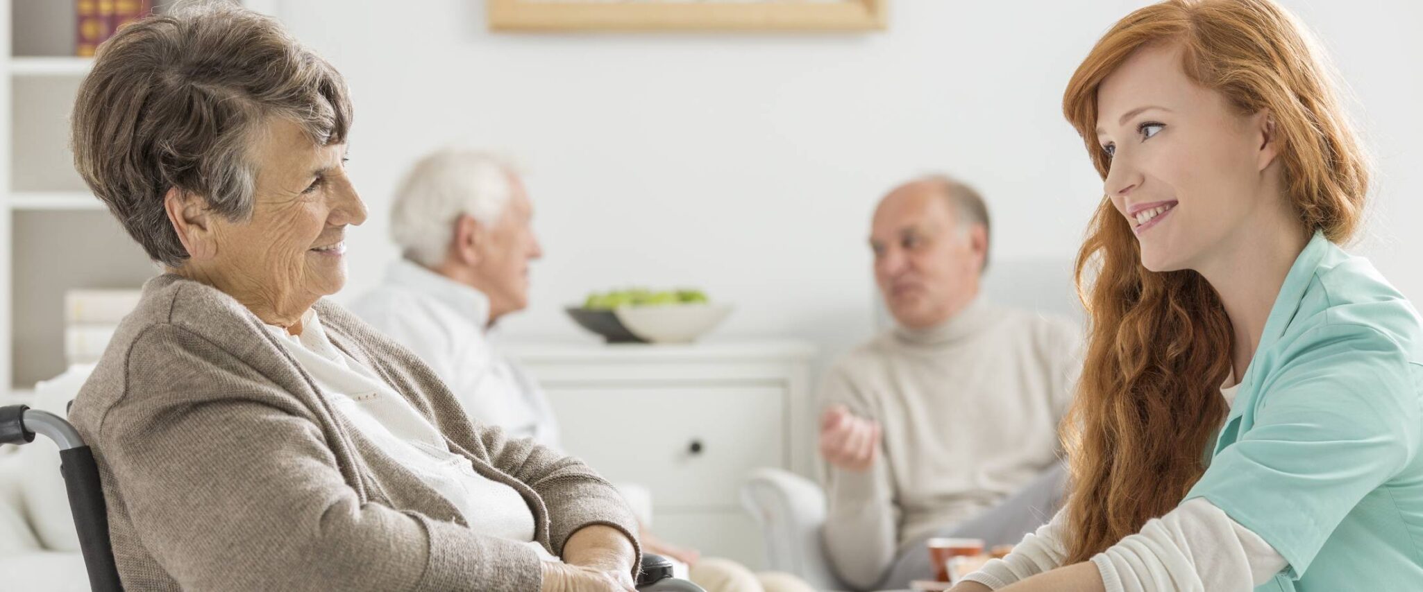 senior lady in a nursing home talking with a nurse