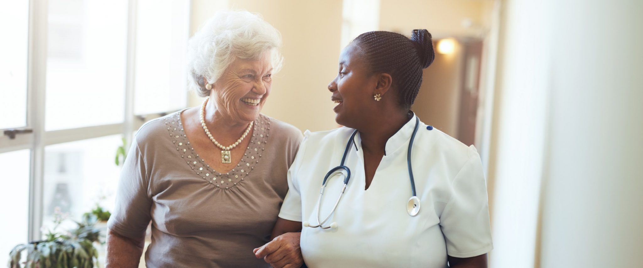 senior with caregiver in respite care at a senior living community