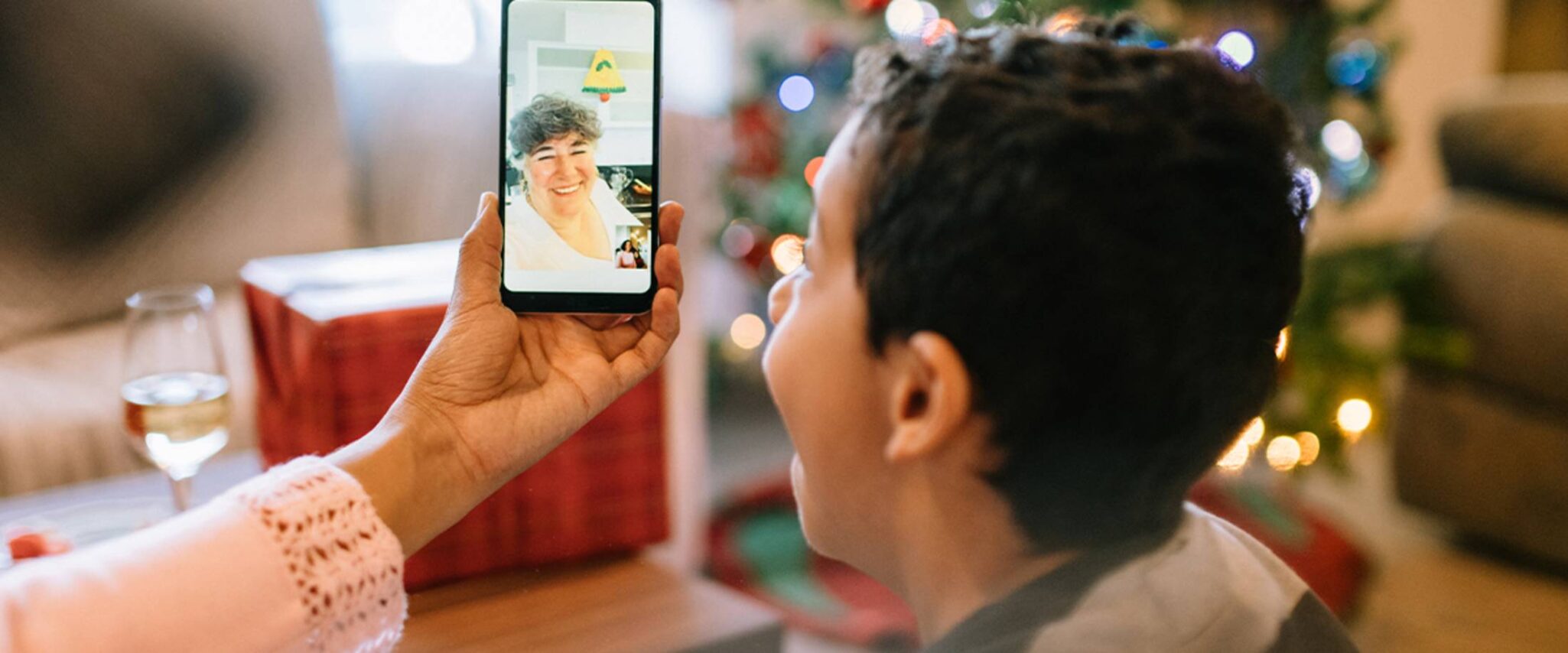 A grandson talks to his grandmother through Facetime or video call on Christmas
