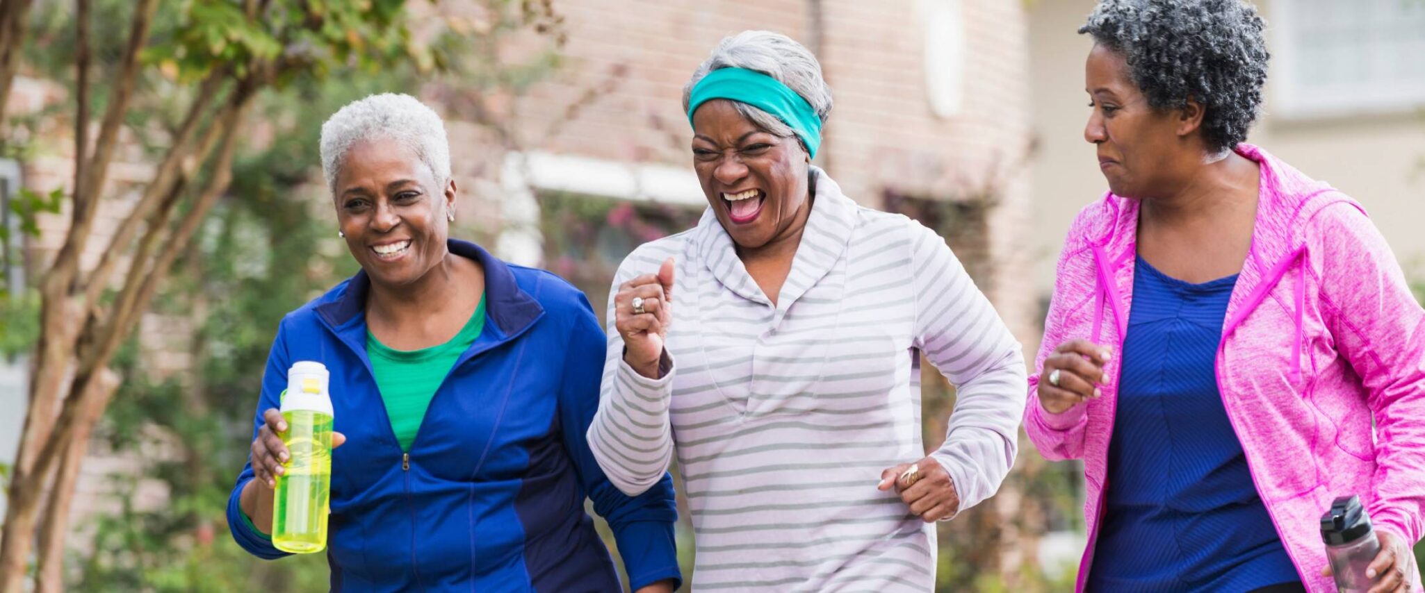 three seniors socializing and exercising in their senior living community