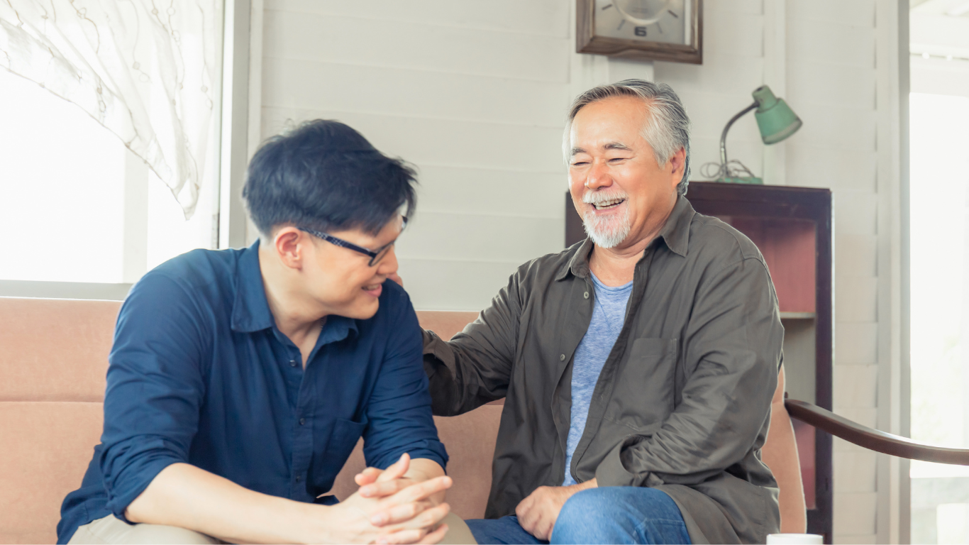 Adult son talking to senior parent