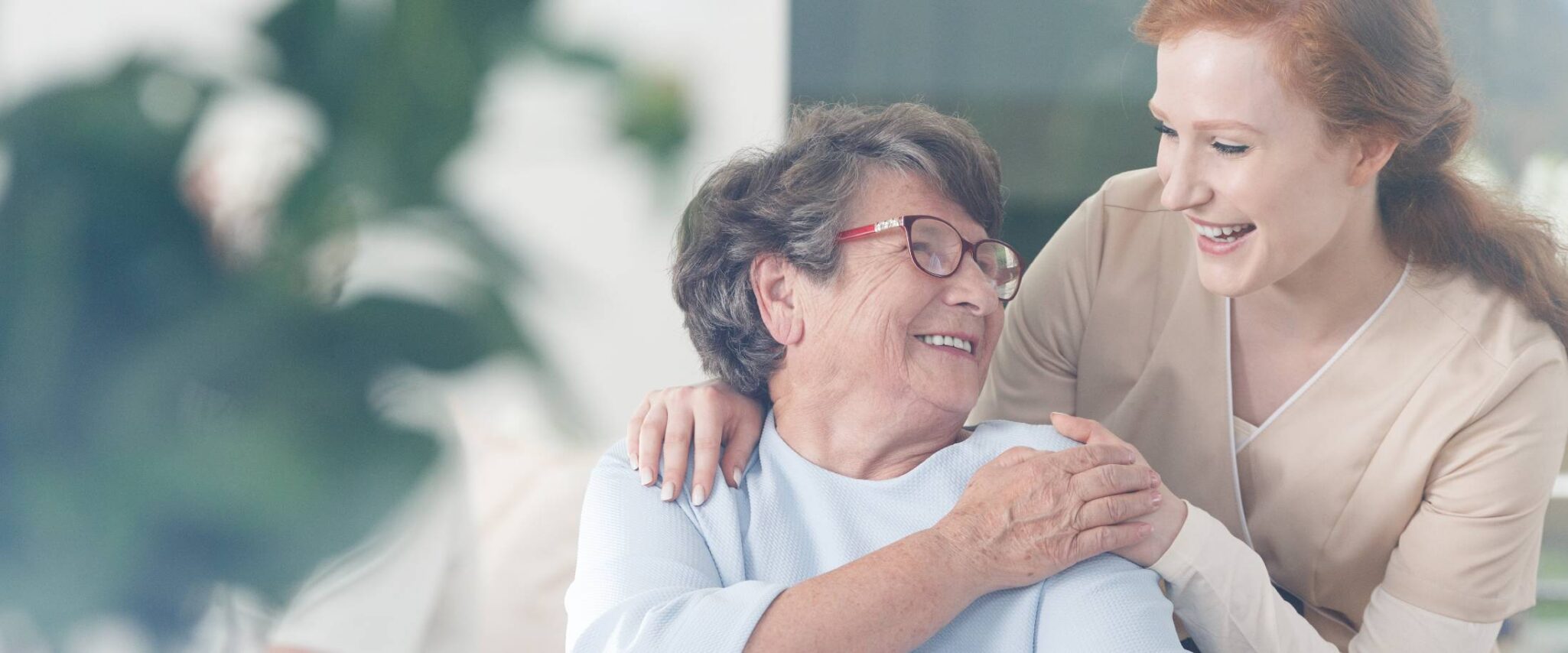 senior talking with a caregiver at a memory care facility