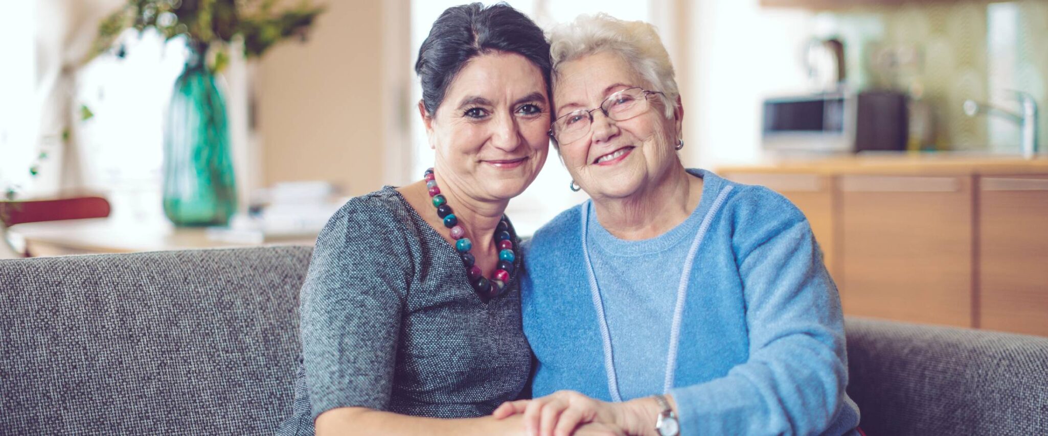 senior with a caregiver smiling looking at the camera