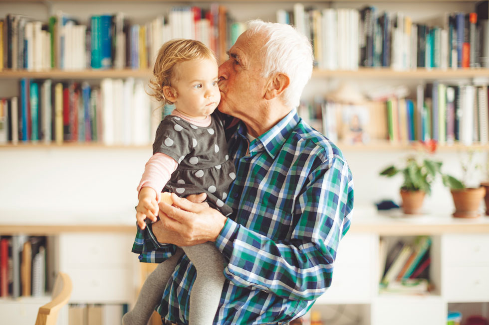 senior man holding his young grandchild