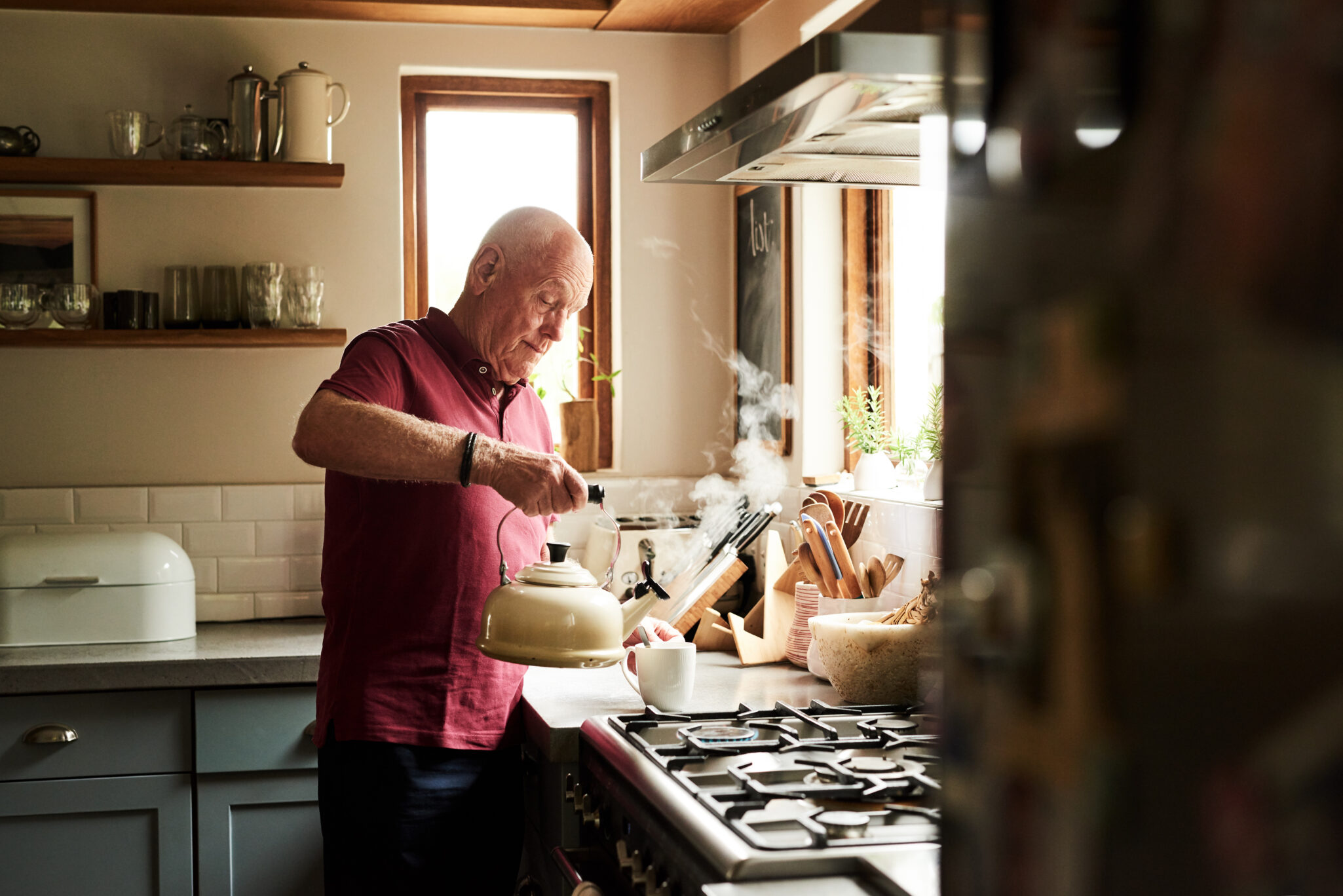 Cropped shot of a senior man preparing a hot beverage at home