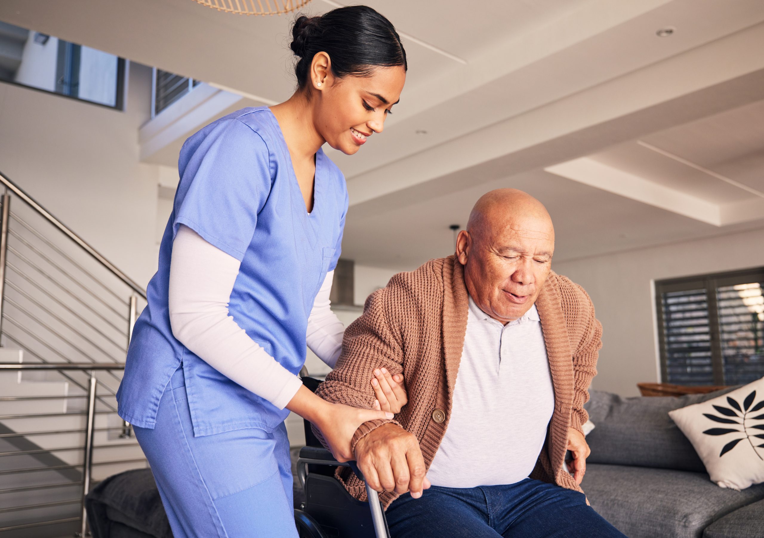 Female nurse assisting senior male in wheelchair